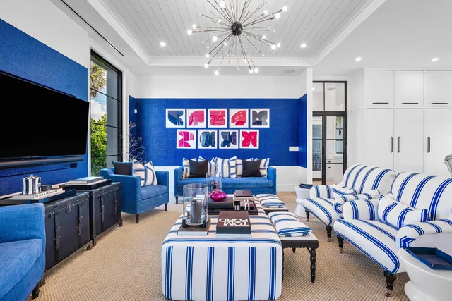 a living room with furniture kitchen view and a large window