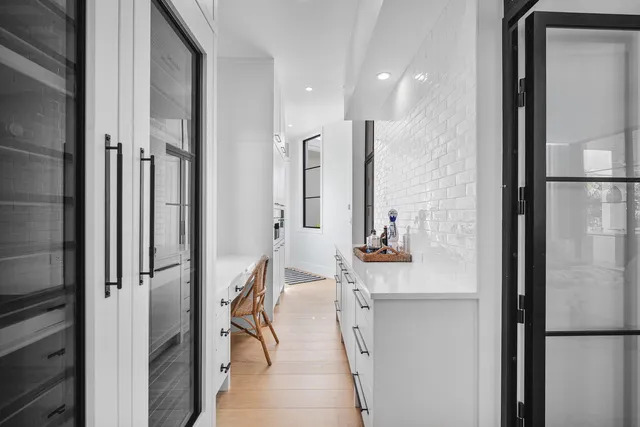 a bathroom with a toilet a sink and a large mirror