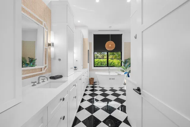 a view of a bathroom with a black and white checkered floor