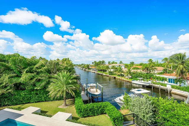 a bedroom with a large bed and a flat tv screen on dresser