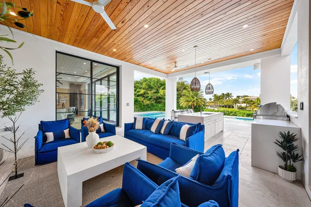 a living room with furniture a large window and a flat screen tv