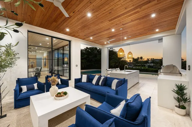 an aerial view of a house with a garden and lake view