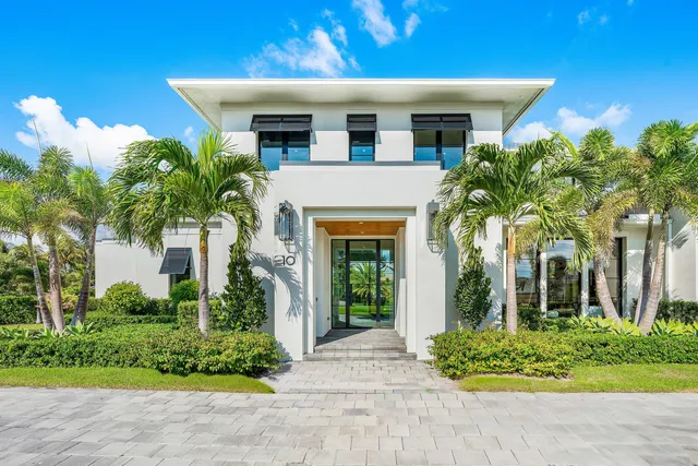 a living room with furniture and large windows