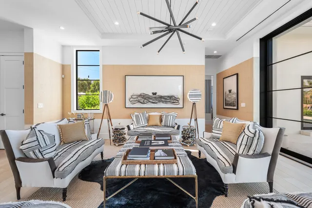a living room with furniture a wooden floor and a chandelier