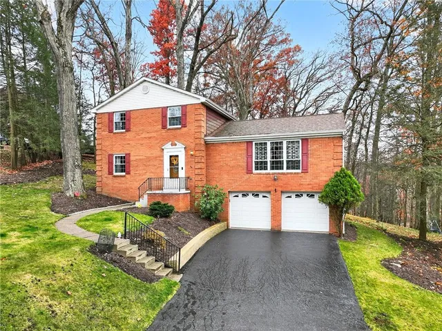 a front view of a house with a yard and outdoor seating
