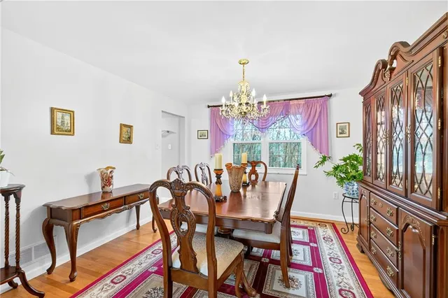 a view of a dining room with furniture and chandelier
