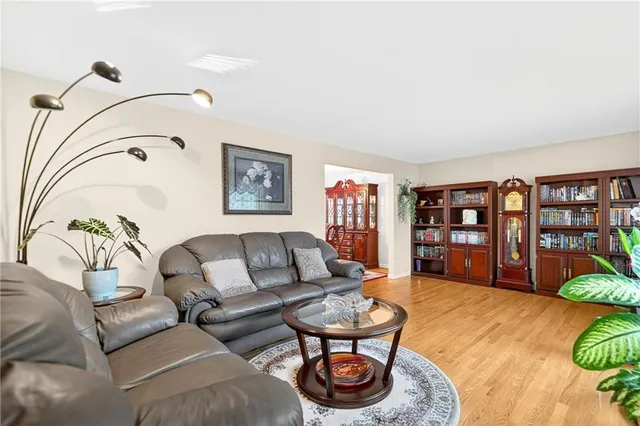 a living room with furniture and book shelf