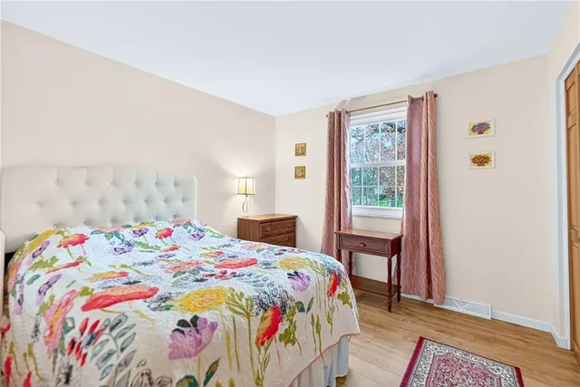 a bedroom with a bed and a dresser in it