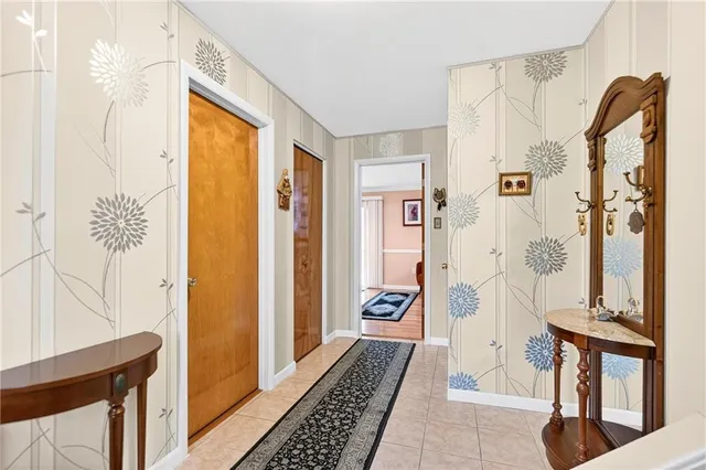 a view of a bathroom with shower and mirror