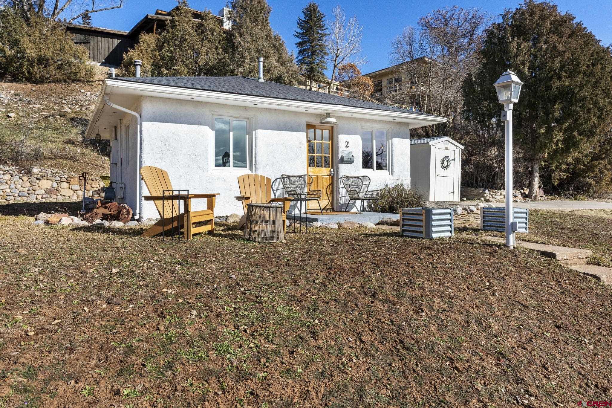 a view of a house with backyard and sitting area