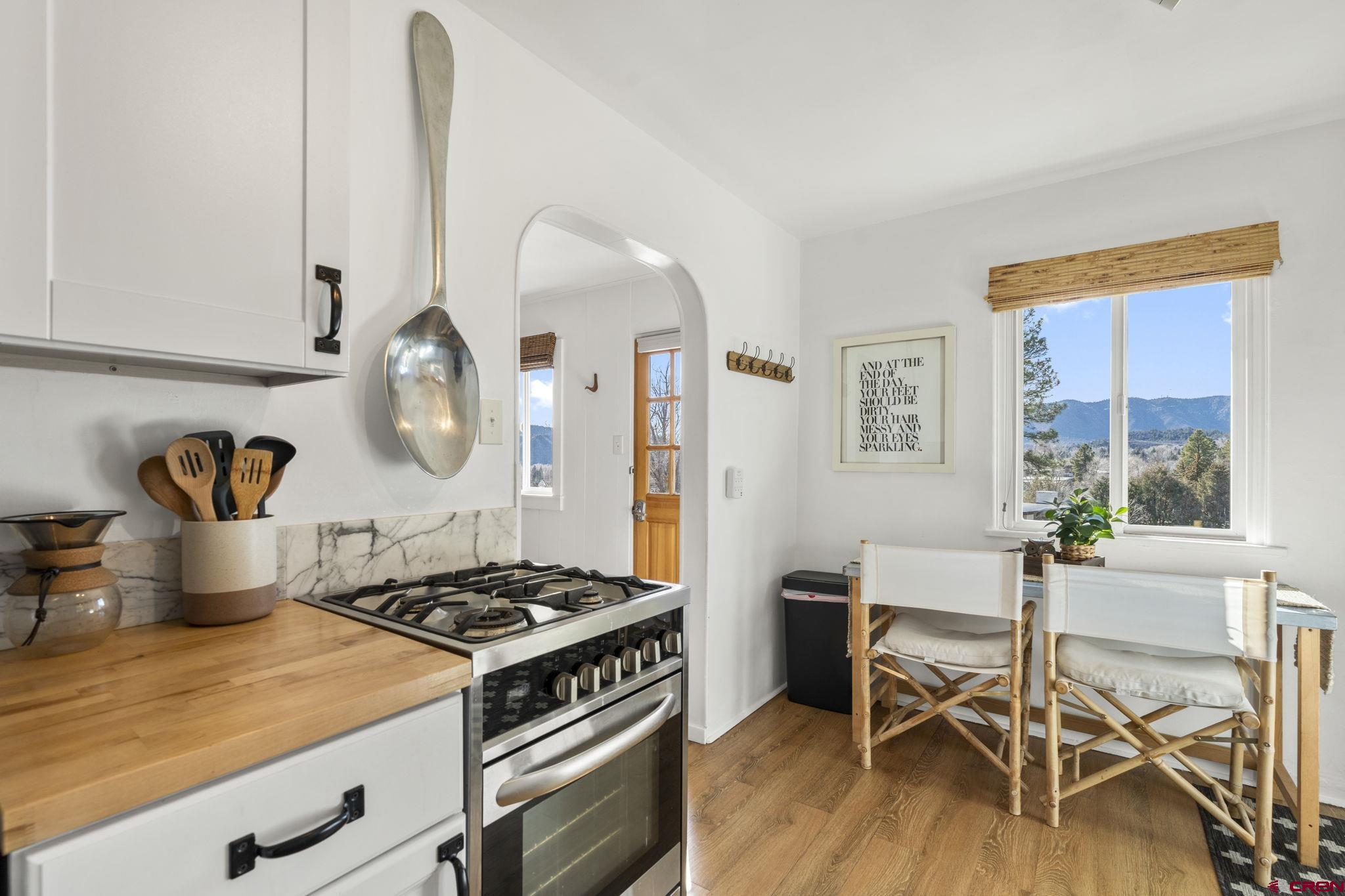 2 Carol Drive Durango, CO 81301 - Photo 2 of 41 a kitchen with a stove and a wooden floor