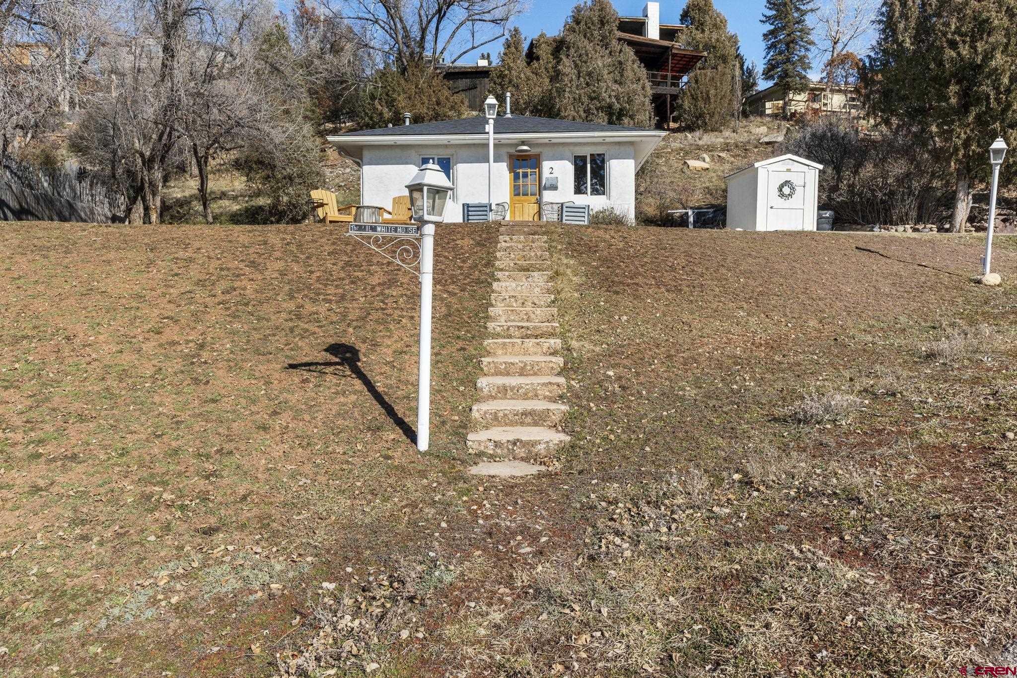 2 Carol Drive Durango, CO 81301 - Photo 30 of 41 a front view of a house with a yard and garage