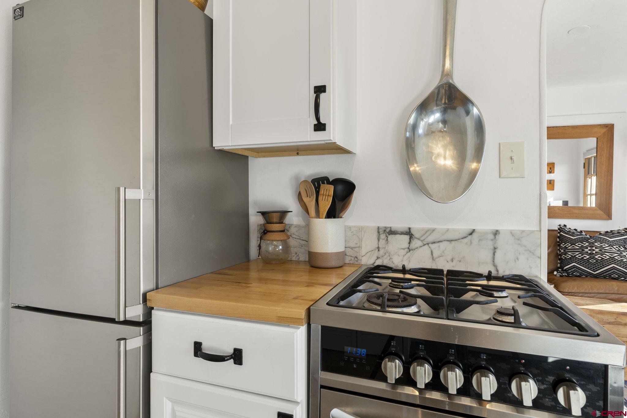 2 Carol Drive Durango, CO 81301 - Photo 5 of 41 a kitchen with a stove and a wooden floor