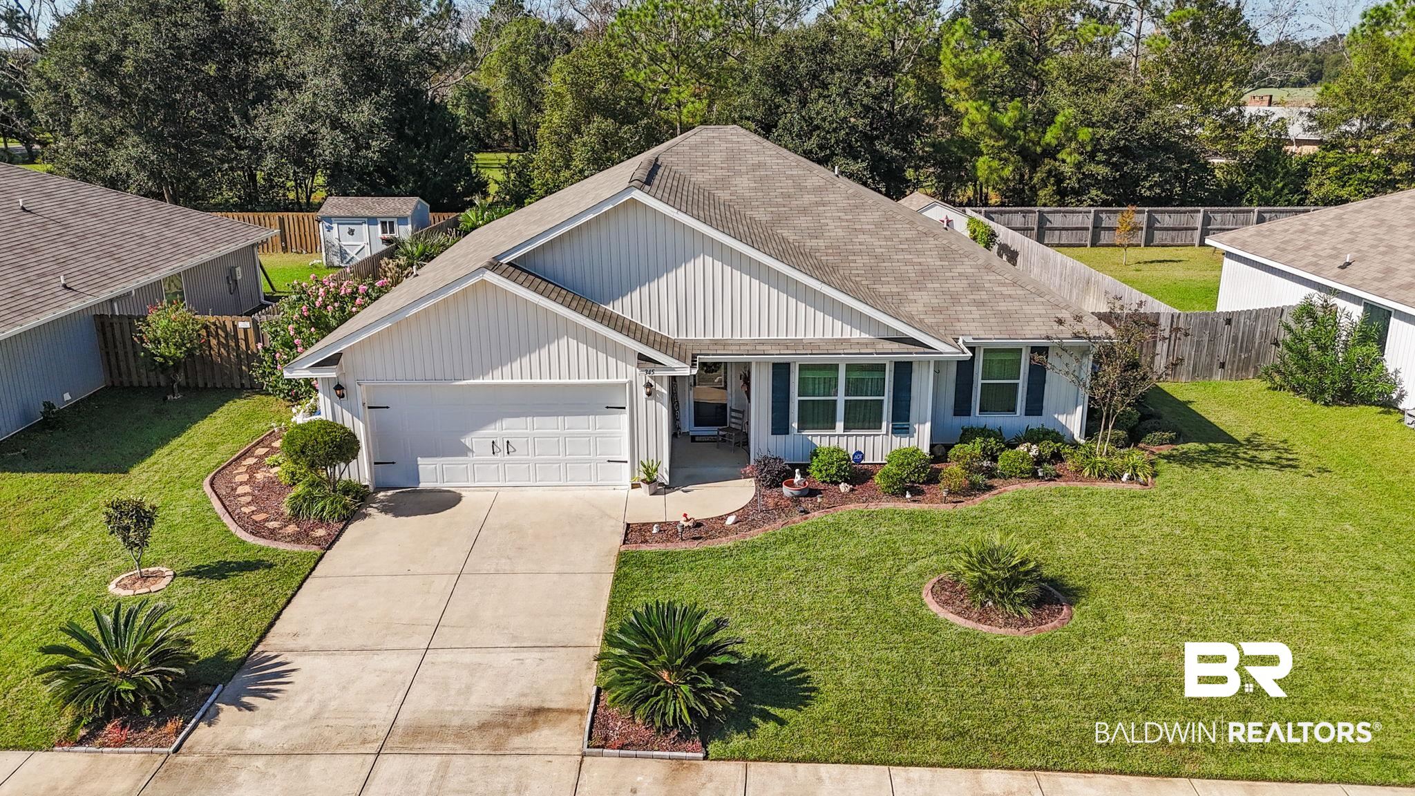 345 Hartenstein Road Foley, AL 36535 - Photo 12 of 47 View of front facade featuring a garage and a front lawn
