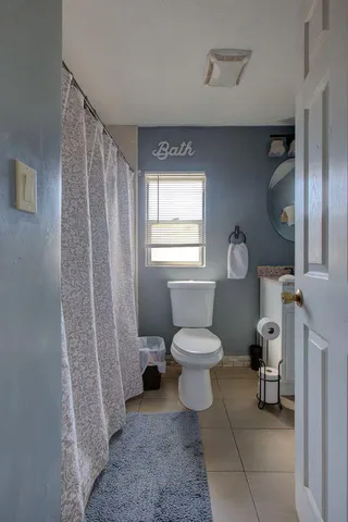 a bed sitting in a bedroom next to a chandelier