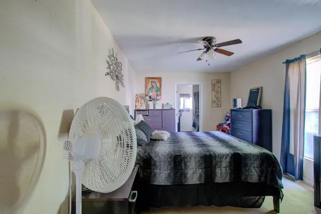 a bedroom with a bed and a dresser