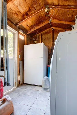 a view of a chairs and tables in the back yard of the house