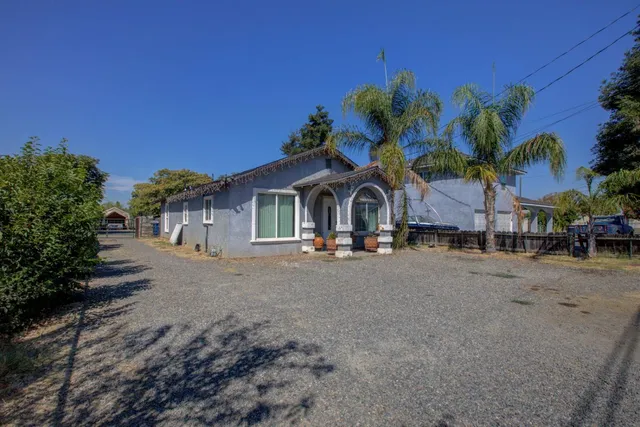 a view of a street with palm trees