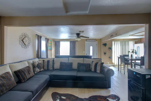 a living room with furniture and a mirror