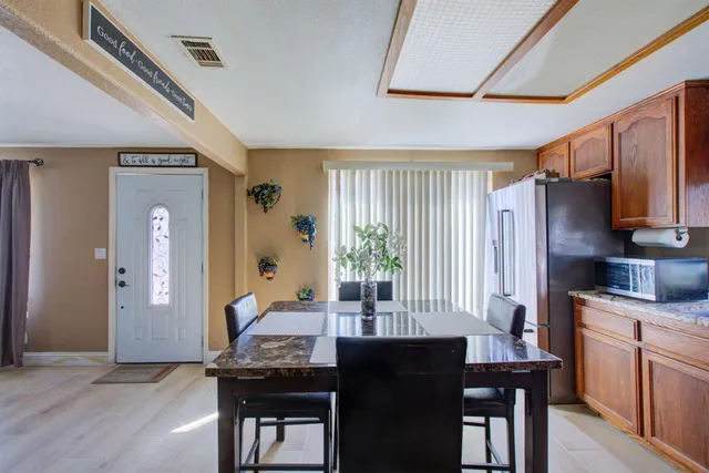 a kitchen with granite countertop lots of counter top space and stainless steel appliances