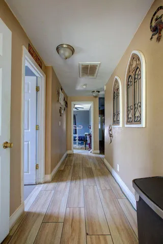 a living room with furniture a flat screen tv and a window