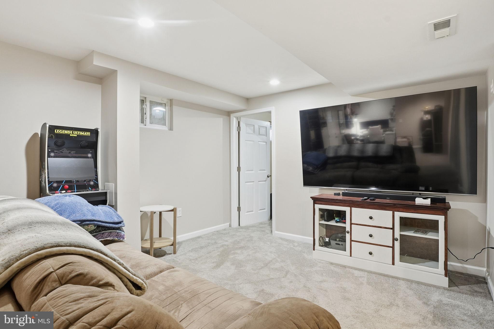 16402 Baden Naylor Road Brandywine, MD 20613 - Photo 26 of 37 a living room with furniture and a flat screen tv