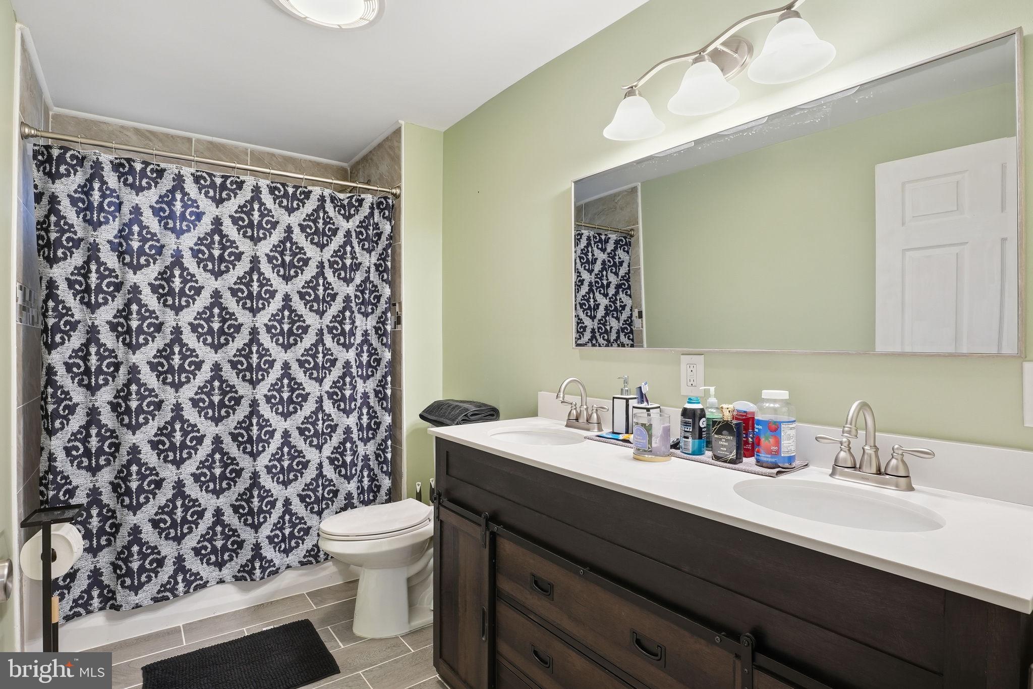16402 Baden Naylor Road Brandywine, MD 20613 - Photo 27 of 37 a bathroom with a sink and a mirror