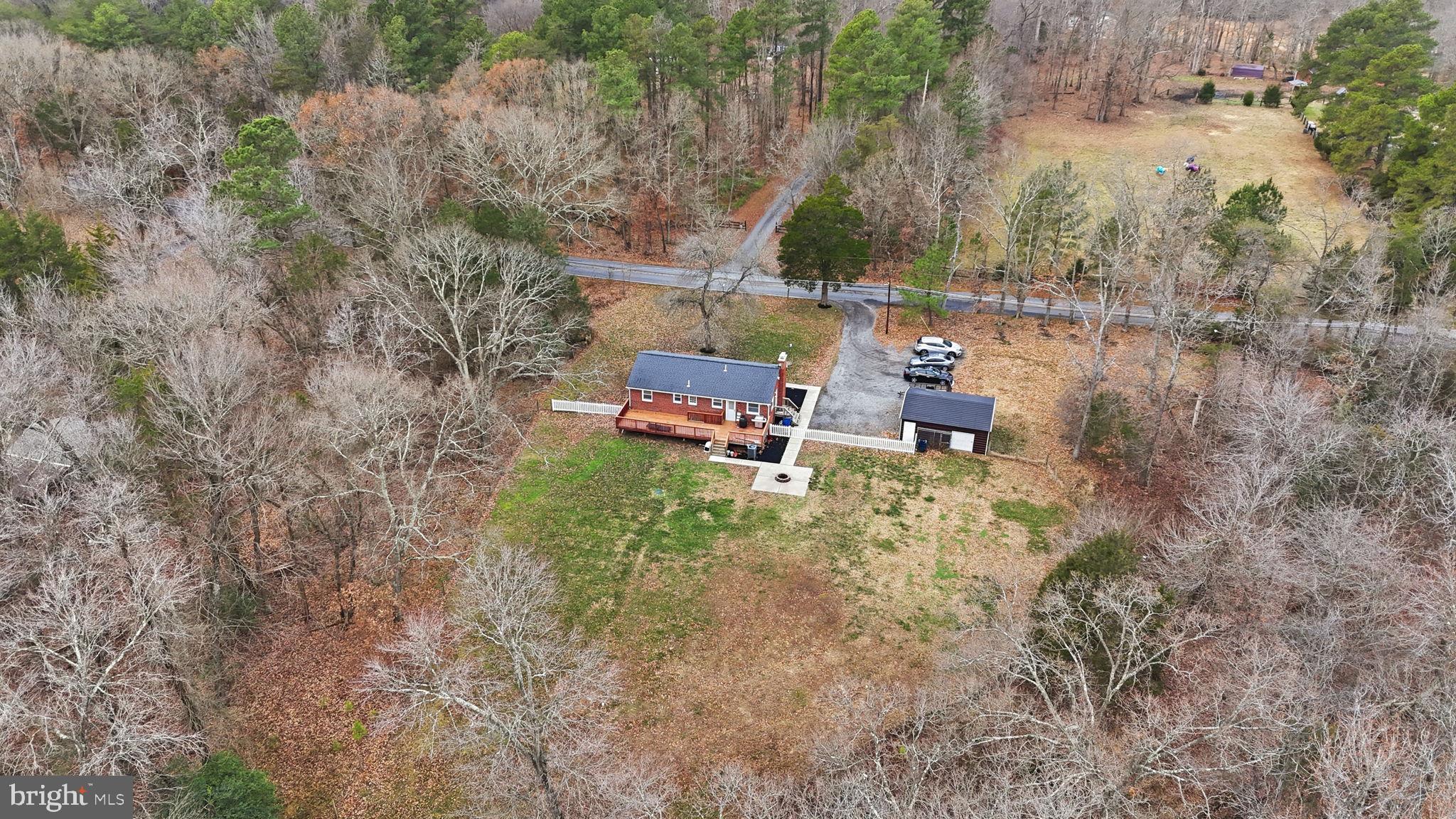 16402 Baden Naylor Road Brandywine, MD 20613 - Photo 36 of 37 a backyard of a house with outdoor seating and trees