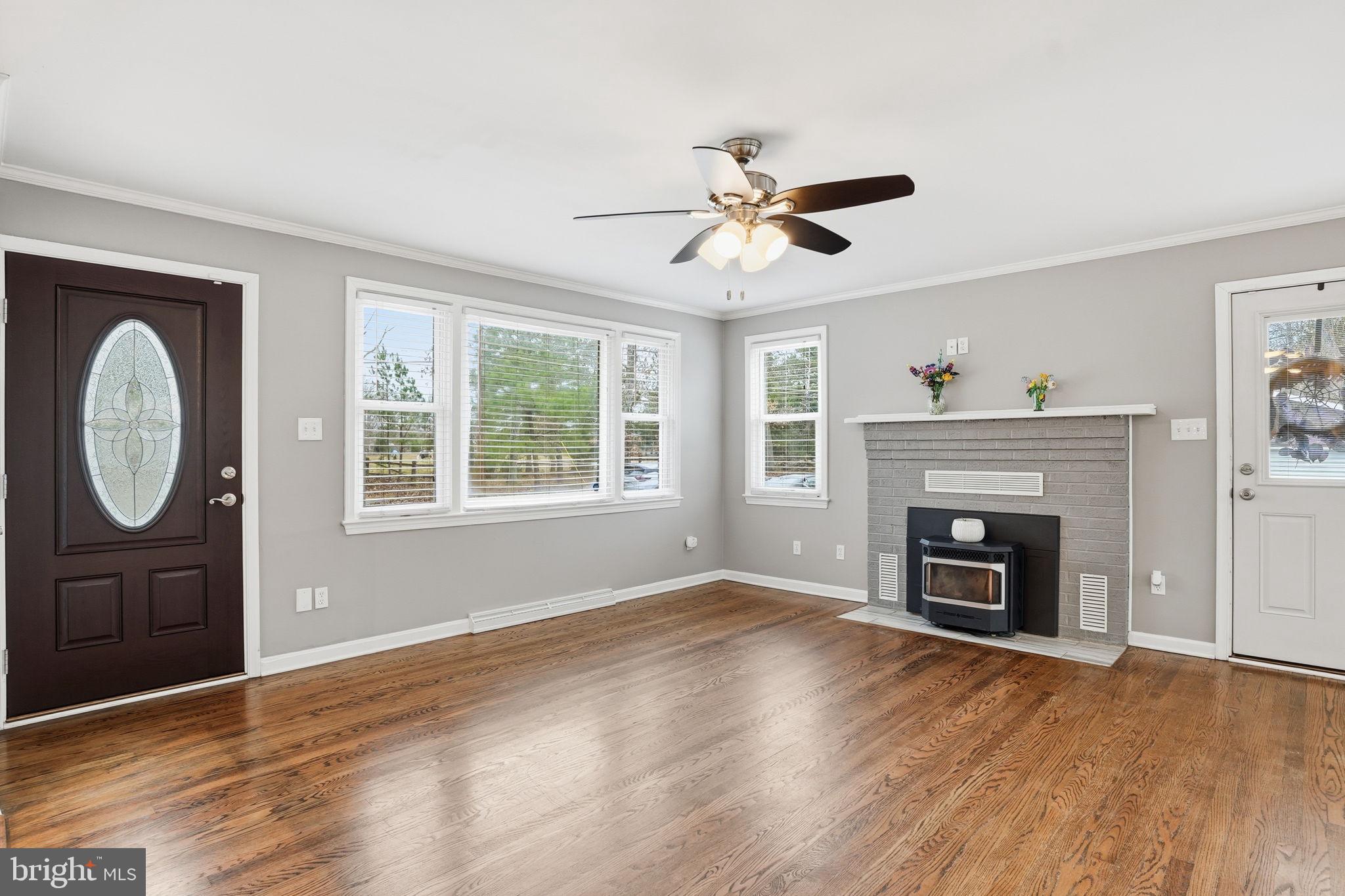 16402 Baden Naylor Road Brandywine, MD 20613 - Photo 8 of 37 a view of an empty room with wooden floor fireplace and a window