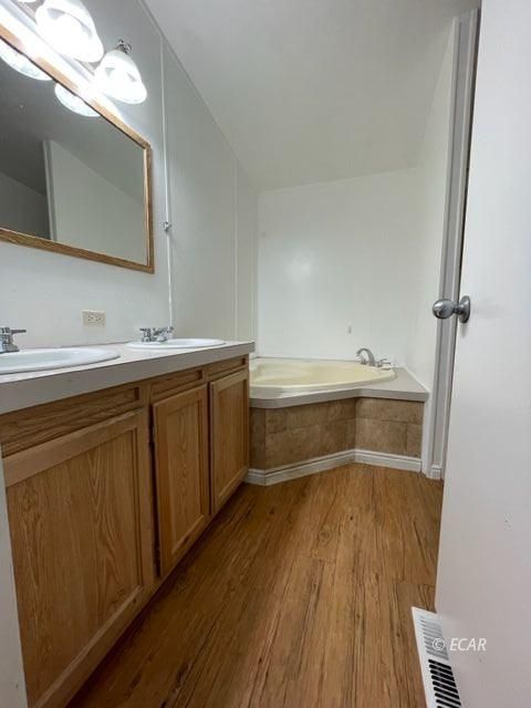 473 Spring Valley Parkway Spring Creek, NV 89815 - Photo 29 of 40 a bathroom with a sink a large mirror and vanity