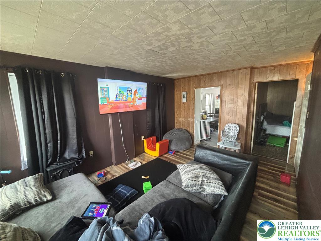 3404 North Ruch Street Whitehall, PA 18052 - Photo 20 of 36 A relaxed living area offers a comfortable setting, featuring warm wood-paneled walls.