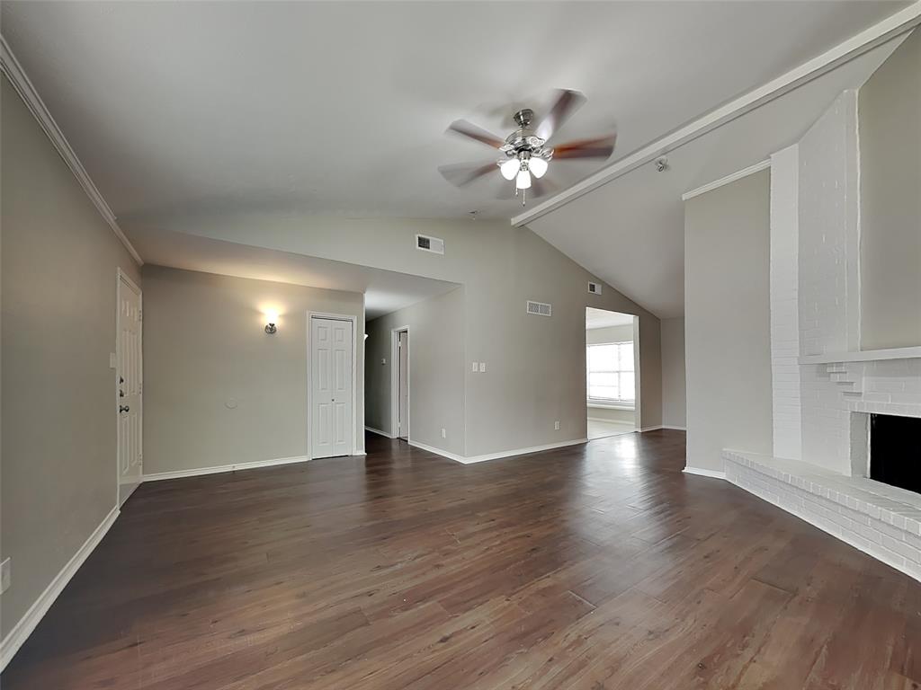 7621 Pebble Beach Drive Rowlett, TX 75088 - Photo 2 of 20 a view of an empty room with wooden floor and a window