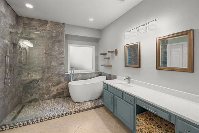 a bathroom with a double vanity sink a mirror and a bathtub