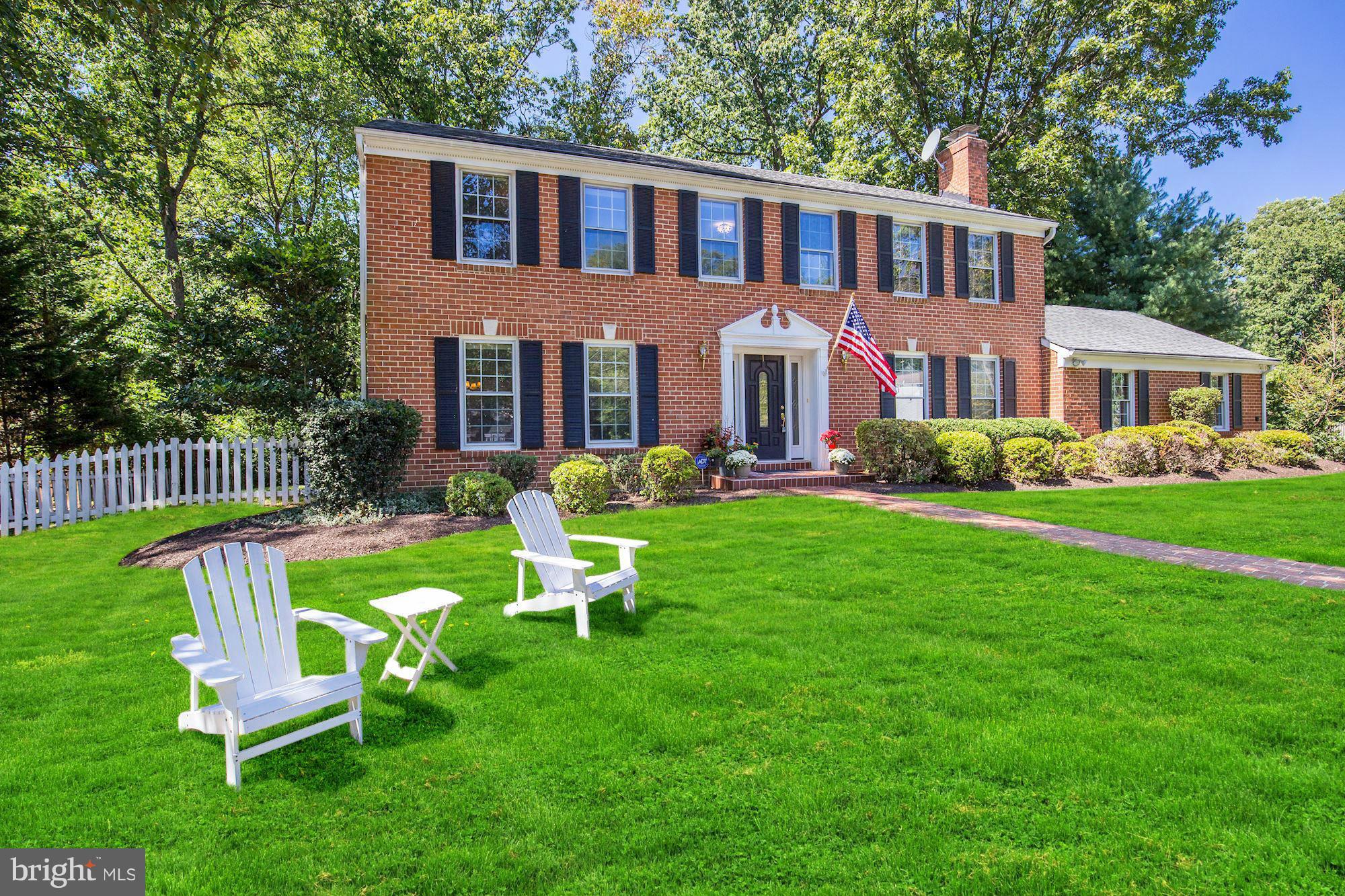 9019 Edgepark Road Vienna, VA 22182 - Photo 1 of 30 a front view of a house with a yard table and chairs