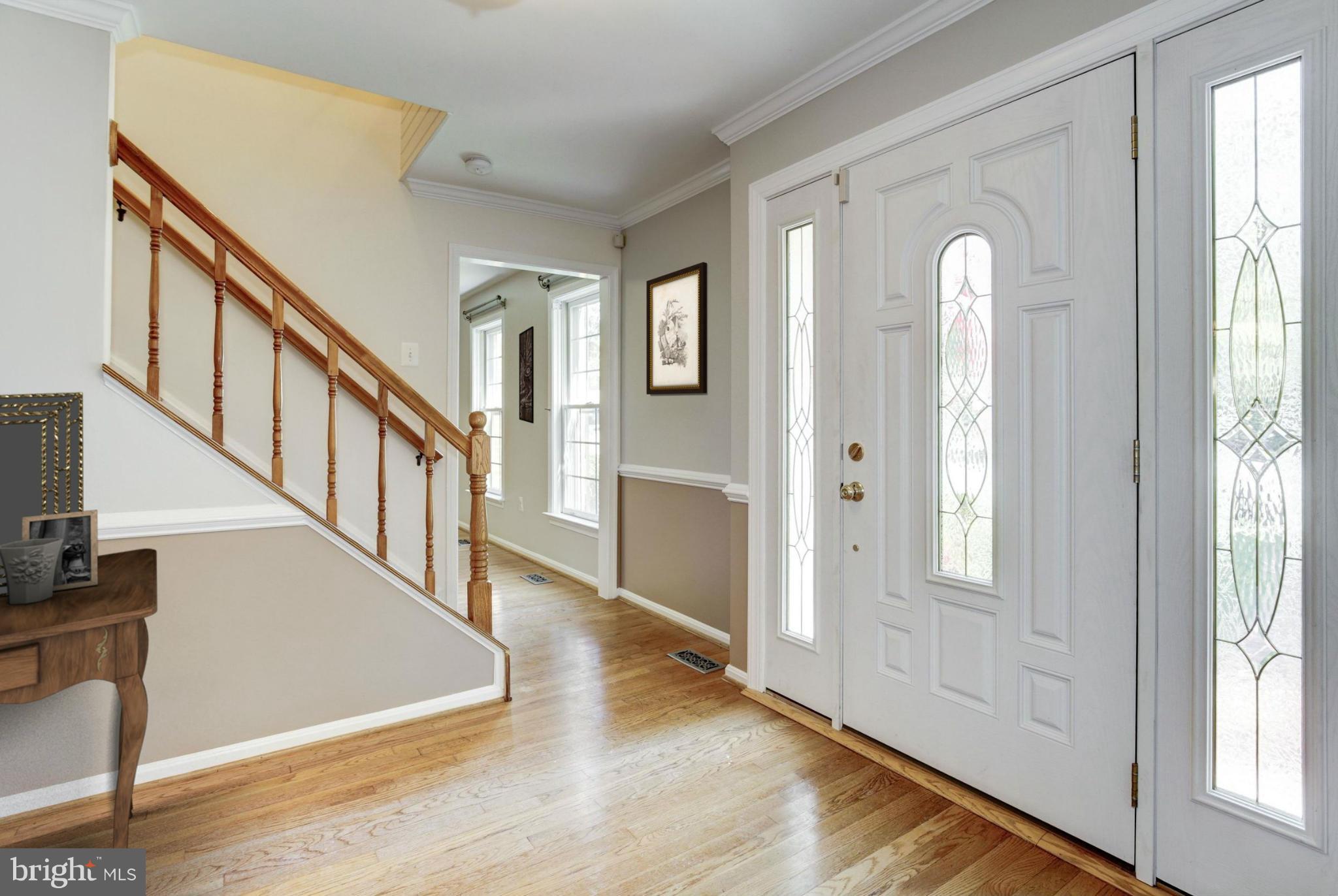 9019 Edgepark Road Vienna, VA 22182 - Photo 2 of 30 a view of an entryway with wooden floor and windows