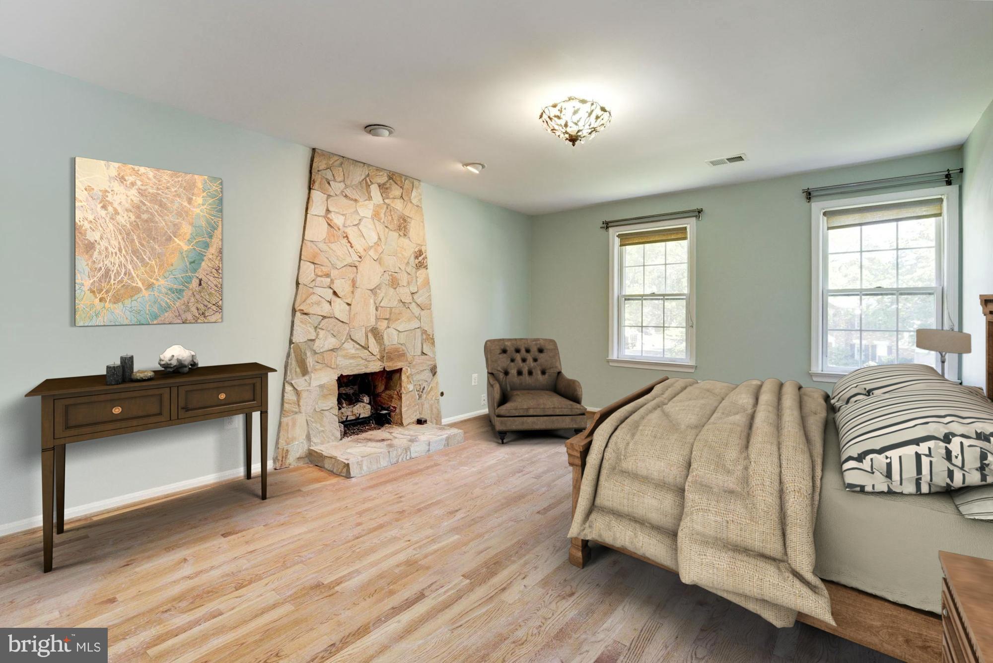 9019 Edgepark Road Vienna, VA 22182 - Photo 11 of 30 a bedroom with a bed and a fireplace