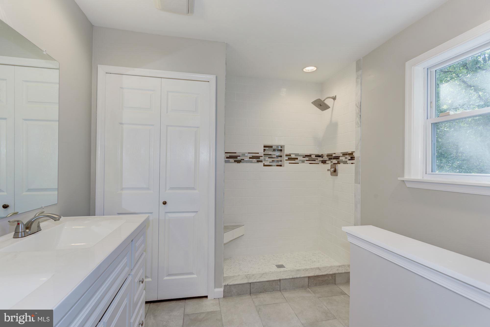 9019 Edgepark Road Vienna, VA 22182 - Photo 13 of 30 a bathroom with a sink a toilet and shower