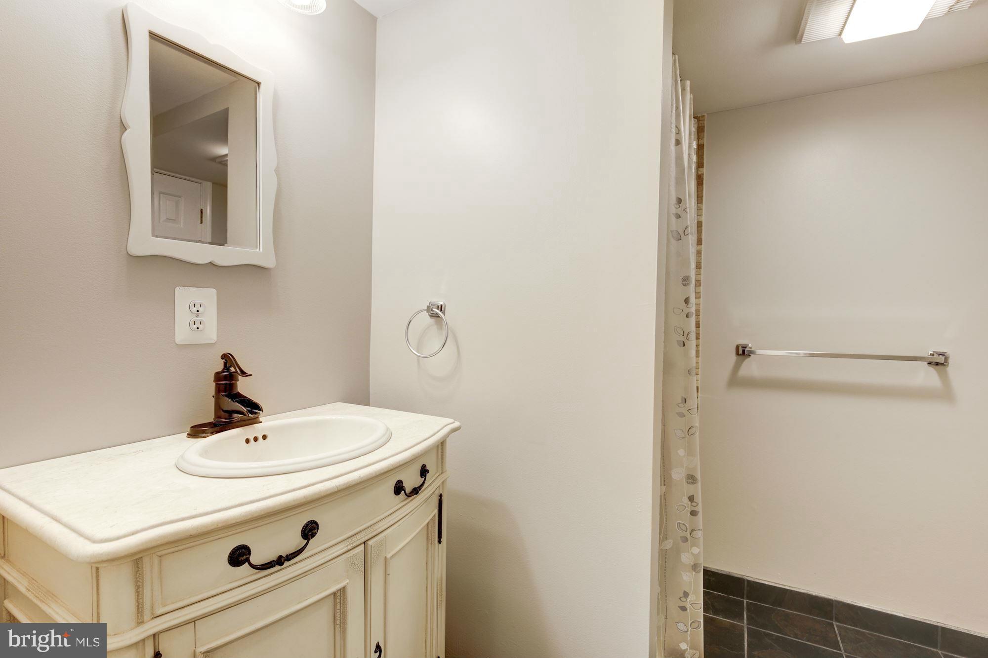 9019 Edgepark Road Vienna, VA 22182 - Photo 21 of 30 a bathroom with a sink a mirror and vanity