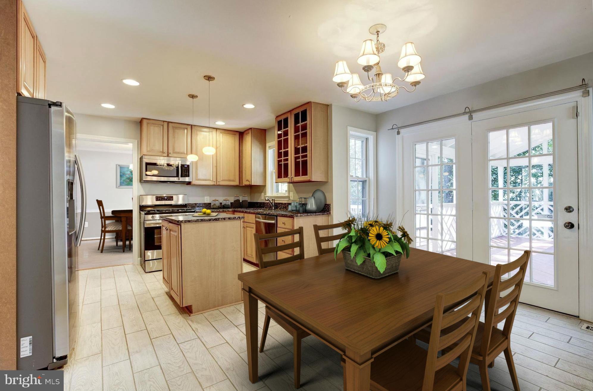 9019 Edgepark Road Vienna, VA 22182 - Photo 8 of 30 a kitchen with stainless steel appliances granite countertop a stove a refrigerator a kitchen island a dining table and chairs