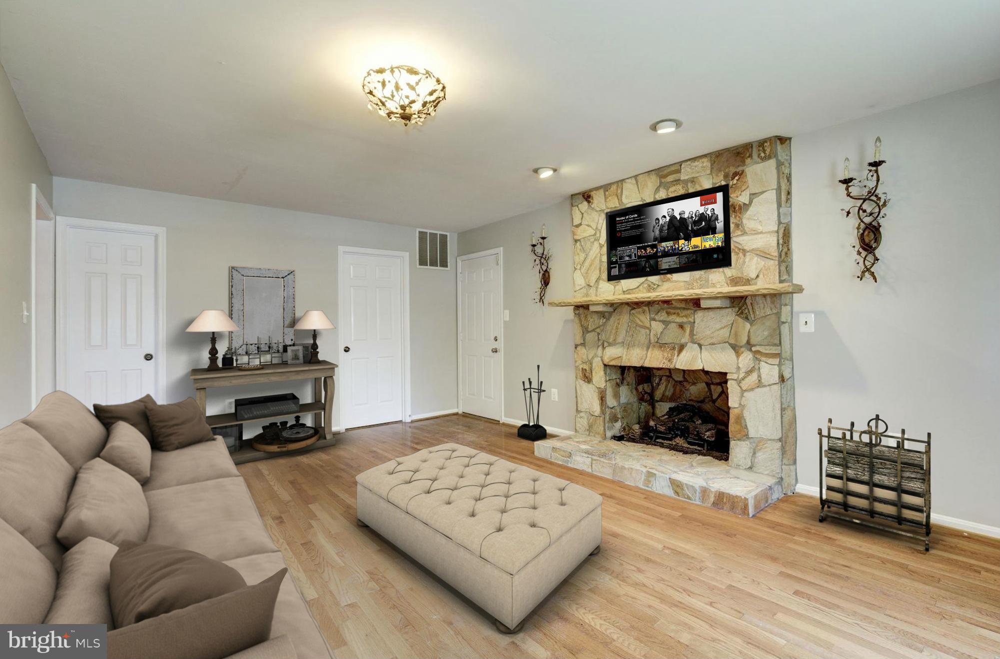 9019 Edgepark Road Vienna, VA 22182 - Photo 10 of 30 a living room with furniture a flat screen tv and a fireplace