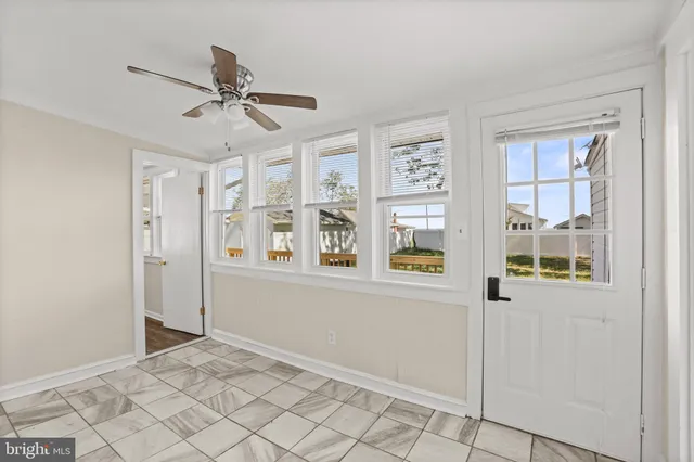 a view of an entryway with wooden floor and windows