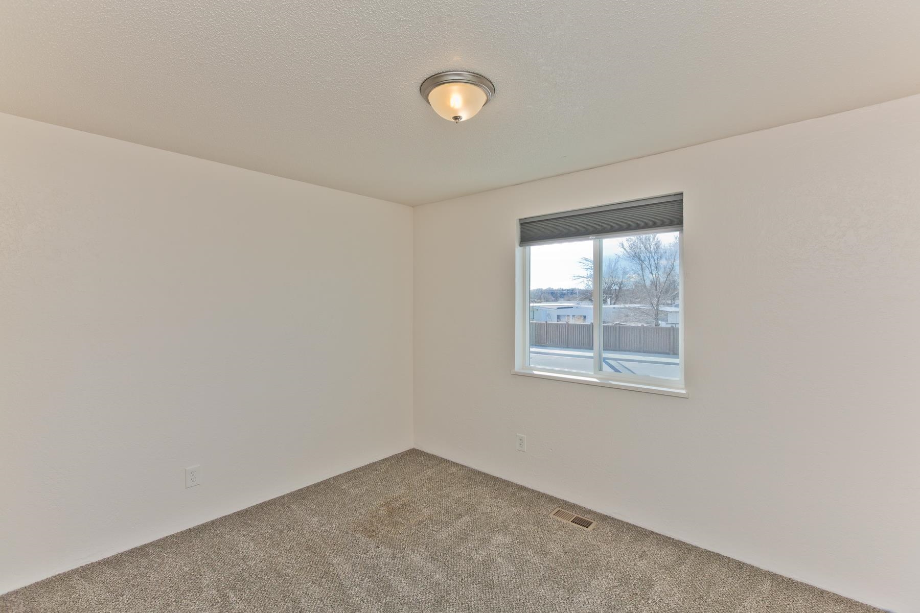 3212 D D 1/4 Road Clifton, CO 81520 - Photo 6 of 25 an empty room with a window