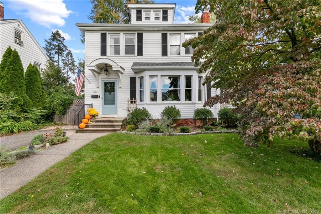 a front view of a house with patio and garden