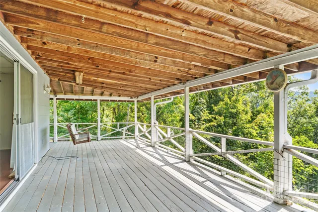 a view of a balcony with wooden floor