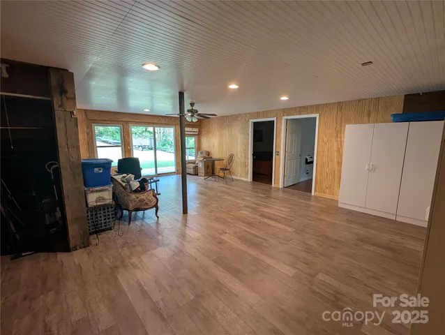 a view of a kitchen with furniture and a refrigerator