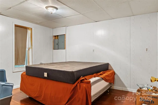 a bedroom with bed and mirror