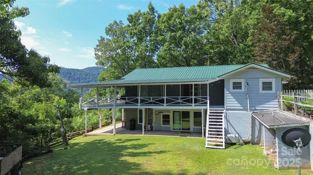 a view of a house with a yard and sitting area