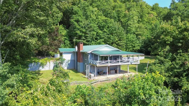 an aerial view of a house with a big yard