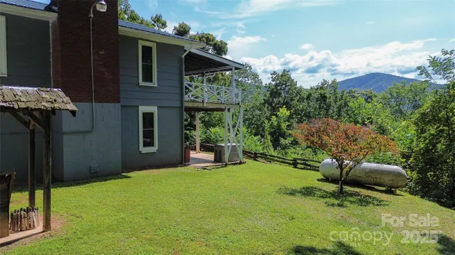 a backyard of a house with table and chairs