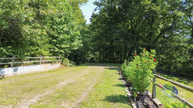 a view of a swimming pool with an outdoor seating and a forest
